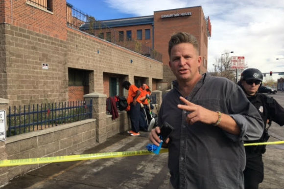 PJ D'Amico stands vigil at a homeless sweep in Denver.